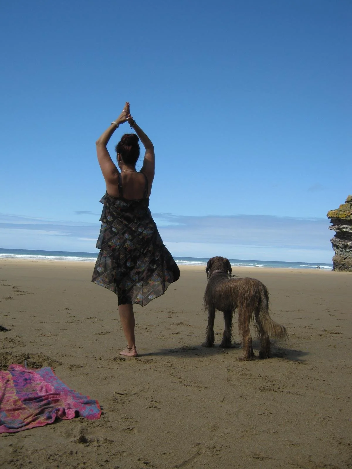 Instructor demonstrating a pose on the beach